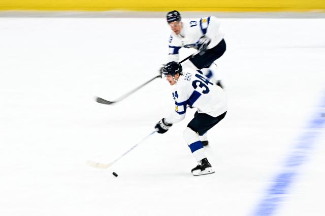 Finland's forward #34 Aatu Raty (front) controls the puck during the IIHF Ice Hockey Men's World Championship semi-final match between Canada and Finland at the Swiss Life Arena in Zurich, on May 30, 2026. (Photo by Fabrice COFFRINI / AFP)