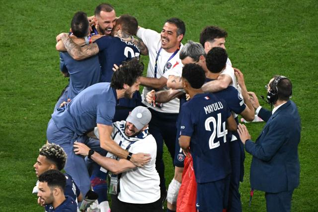 Paris Saint-Germain players and team members celebrate after winning the UEFA Champions League final football match between Paris Saint-Germain (PSG) and Arsenal FC at the Puskas Arena in Budapest on May 30, 2026. (Photo by Attila KISBENEDEK / AFP)