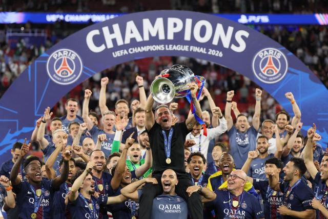 Paris Saint-Germain's Spanish head coach Luis Enrique lifts the trophy after winning the UEFA Champions League final football match between Paris Saint-Germain (PSG) and Arsenal FC at the Puskas Arena in Budapest on May 30, 2026. (Photo by Odd ANDERSEN / AFP)