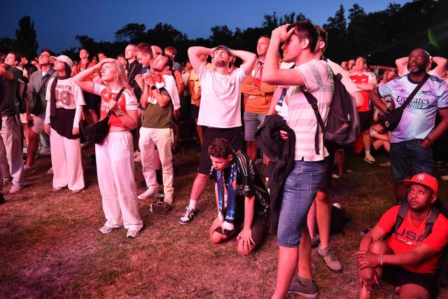 Arsenal supporters react in a fan zone during the penalty shoot out of the UEFA Champions League final football match between Paris Saint-Germain (PSG) and Arsenal FC in Budapest on May 30, 2026. (Photo by Ferenc ISZA / AFP)