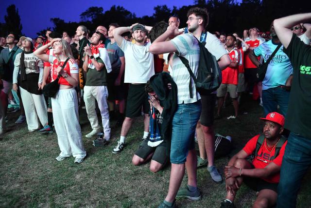 Arsenal supporters react in a fan zone during the penalty shoot out of the UEFA Champions League final football match between Paris Saint-Germain (PSG) and Arsenal FC in Budapest on May 30, 2026. (Photo by Ferenc ISZA / AFP)