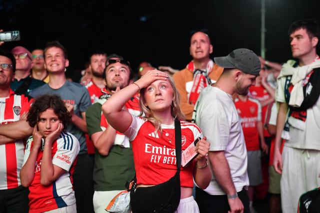 Arsenal supporters react in a fan zone during the penalty shoot out of the UEFA Champions League final football match between Paris Saint-Germain (PSG) and Arsenal FC in Budapest on May 30, 2026. (Photo by Ferenc ISZA / AFP)