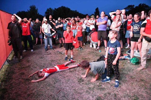 Kids react in a fan zone during the penalty shoot out of the UEFA Champions League final football match between Paris Saint-Germain (PSG) and Arsenal FC in Budapest on May 30, 2026. (Photo by Ferenc ISZA / AFP)