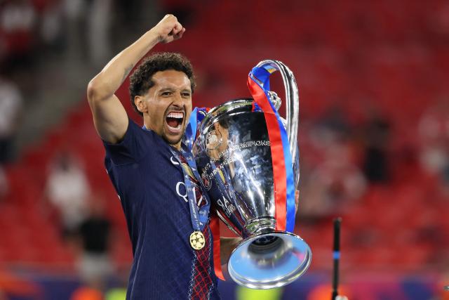 Paris Saint-Germain's Brazilian defender #05 Marquinhos lifts the trophy after winning the UEFA Champions League final football match between Paris Saint-Germain (PSG) and Arsenal FC at the Puskas Arena in Budapest on May 30, 2026. (Photo by Odd ANDERSEN / AFP)