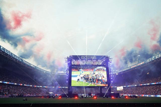 PSG supporters watch on a giant screen the UEFA Champions League trophy ceremony after Paris Saint-Germain (PSG) won the final football match against Arsenal FC played in Budapest, at the Parc des Princes stadium, in Paris on May 30, 2026. (Photo by Kenzo TRIBOUILLARD / AFP)