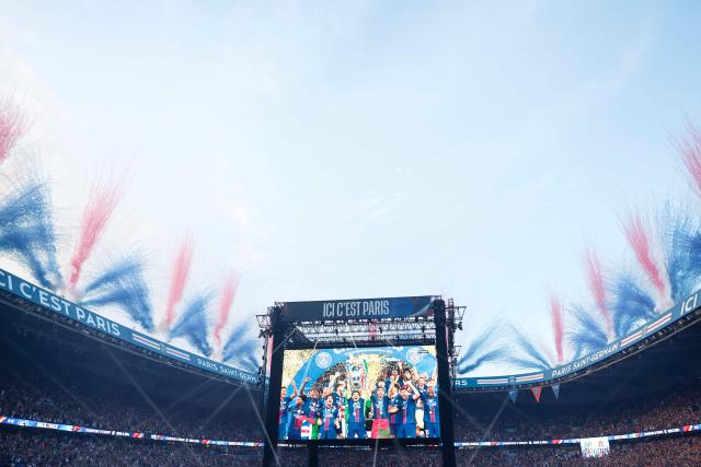 PSG supporters watch on a giant screen the UEFA Champions League trophy ceremony after Paris Saint-Germain (PSG) won the final football match against Arsenal FC played in Budapest, at the Parc des Princes stadium, in Paris on May 30, 2026. (Photo by Kenzo TRIBOUILLARD / AFP)