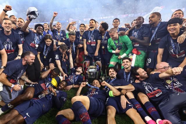 Paris Saint-Germain players celebrate after winning the UEFA Champions League final football match between Paris Saint-Germain (PSG) and Arsenal FC at the Puskas Arena in Budapest on May 30, 2026. (Photo by Franck FIFE / AFP)