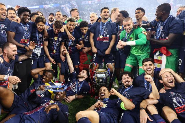 Paris Saint-Germain players celebrate after winning the UEFA Champions League final football match between Paris Saint-Germain (PSG) and Arsenal FC at the Puskas Arena in Budapest on May 30, 2026. (Photo by Franck FIFE / AFP)