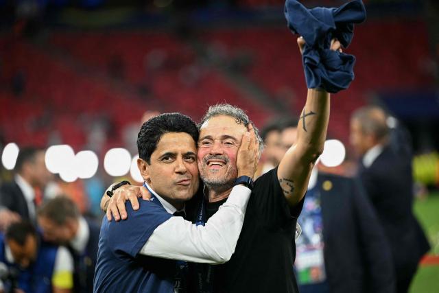 (LtoR) Paris Saint Germain's Qatari president Nasser al-Khelaifi and Paris Saint-Germain's Spanish head coach Luis Enrique celebrate the team's win of the UEFA Champions League final football match between Paris Saint-Germain (PSG) and Arsenal FC at the Puskas Arena in Budapest on May 30, 2026. (Photo by NICOLAS TUCAT / AFP)