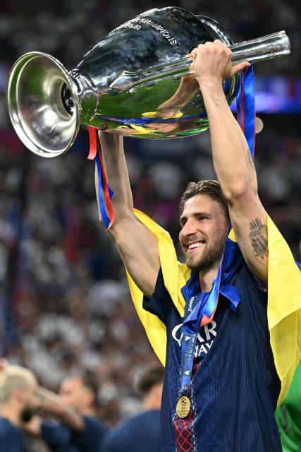 Paris Saint-Germain's Ukrainian defender #06 Illia Zabarnyi celebrates with the trophy after the team's win of the UEFA Champions League final football match between Paris Saint-Germain (PSG) and Arsenal FC at the Puskas Arena in Budapest on May 30, 2026. (Photo by NICOLAS TUCAT / AFP)