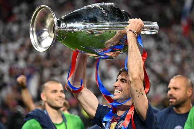 Paris Saint-Germain's Spanish midfielder #08 Fabian Ruiz celebrates with the trophy after the team's win of the UEFA Champions League final football match between Paris Saint-Germain (PSG) and Arsenal FC at the Puskas Arena in Budapest on May 30, 2026. (Photo by NICOLAS TUCAT / AFP)