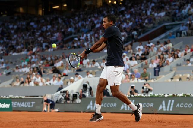 Canada's Felix Auger-Aliassime plays a backhand return to US Brandon Nakashima during their men's singles match on day 7 of the French Open tennis tournament on Court Philippe-Chatrier at the Roland-Garros Complex in Paris on May 30, 2026. (Photo by ALAIN JOCARD / AFP)