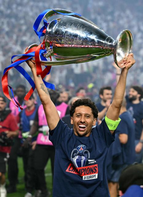Paris Saint-Germain's Brazilian defender #05 Marquinhos celebrates with the trophy after the team's win of the UEFA Champions League final football match between Paris Saint-Germain (PSG) and Arsenal FC at the Puskas Arena in Budapest on May 30, 2026. (Photo by NICOLAS TUCAT / AFP)