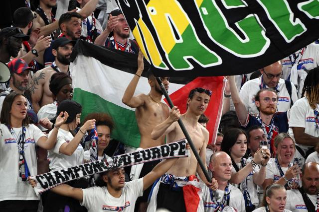 Fans look on after winning the UEFA Champions League final football match between Paris Saint-Germain (PSG) and Arsenal FC at the Puskas Arena in Budapest on May 30, 2026. (Photo by Antonin THUILLIER / AFP)