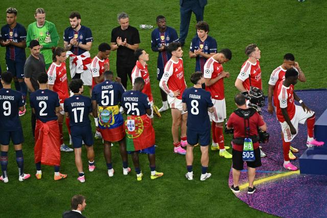 Paris Saint-Germain players applaud Arsenal players as they line up to receive their runners up medals at the end of the UEFA Champions League final football match between Paris Saint-Germain (PSG) and Arsenal FC at the Puskas Arena in Budapest on May 30, 2026. (Photo by Attila KISBENEDEK / AFP)