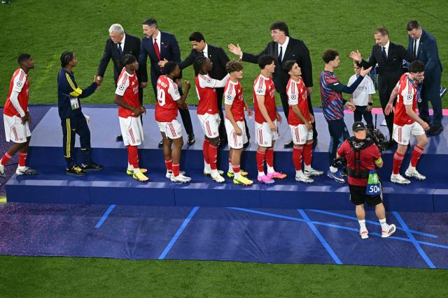 Arsenal players line up to receive their runners up medals at the end of the UEFA Champions League final football match between Paris Saint-Germain (PSG) and Arsenal FC at the Puskas Arena in Budapest on May 30, 2026. (Photo by Attila KISBENEDEK / AFP)