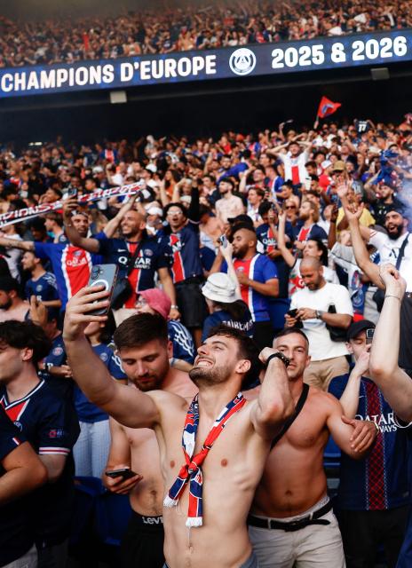 PSG supporters who watched on a giant screen the UEFA Champions League final between Paris Saint-Germain (PSG) and Arsenal FC played in Budapest, celebrate after PSG won, at the Parc des Princes stadium, in Paris on May 30, 2026. (Photo by Kenzo TRIBOUILLARD / AFP)