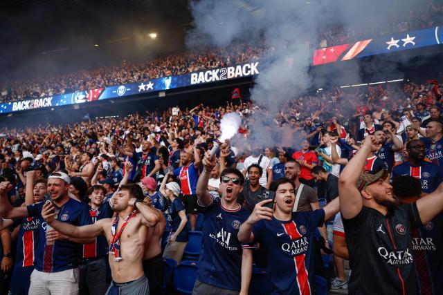 PSG supporters who watched on a giant screen the UEFA Champions League final between Paris Saint-Germain (PSG) and Arsenal FC played in Budapest, celebrate after PSG won, at the Parc des Princes stadium, in Paris on May 30, 2026. (Photo by Kenzo TRIBOUILLARD / AFP)