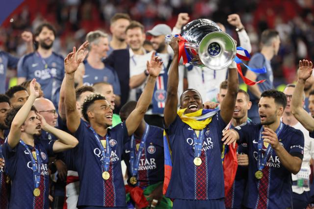 Paris Saint-Germain's Portuguese defender #25 Nuno Mendes lifts the trophy after winning the UEFA Champions League final football match between Paris Saint-Germain (PSG) and Arsenal FC at the Puskas Arena in Budapest on May 30, 2026. (Photo by Odd ANDERSEN / AFP)