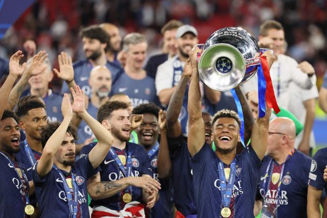 Paris Saint-Germain's French midfielder #14 Desire Doue lifts the trophy after winning the UEFA Champions League final football match between Paris Saint-Germain (PSG) and Arsenal FC at the Puskas Arena in Budapest on May 30, 2026. (Photo by Odd ANDERSEN / AFP)