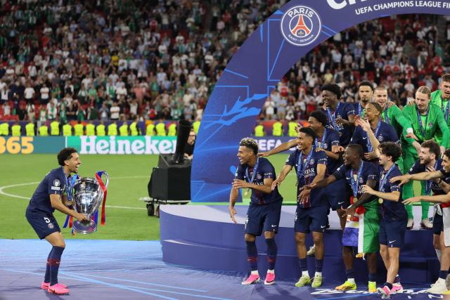 Paris Saint-Germain's Brazilian defender #05 Marquinhos carries the trophy after winning the UEFA Champions League final football match between Paris Saint-Germain (PSG) and Arsenal FC at the Puskas Arena in Budapest on May 30, 2026. (Photo by Odd ANDERSEN / AFP)