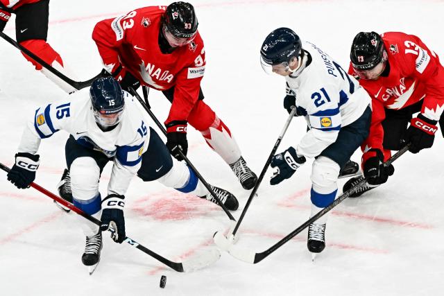 Canada’s forward #13 Gabriel Vilardi (R) and Canada’s forward #93 Fraser Minten (2ndL) fight for the puck with Finland's forward #15 Anton Lundell (L) and Finland's forward #21 Patrik Puistola  during the IIHF Ice Hockey Men's World Championship semi-final match between Canada and Finland at the Swiss Life Arena in Zurich, on May 30, 2026. (Photo by Fabrice COFFRINI / AFP)