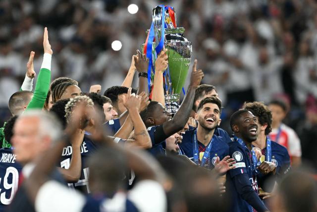Paris Saint-Germain's players lift the trophy as they celebrate their team's win of the UEFA Champions League final football match between Paris Saint-Germain (PSG) and Arsenal FC at the Puskas Arena in Budapest on May 30, 2026. (Photo by NICOLAS TUCAT / AFP)