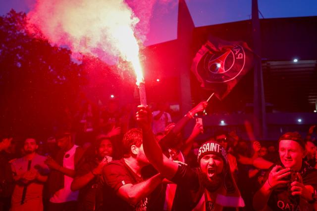 PSG supporters celebrate their team's win in the UEFA Champions League final BETWEEN Paris Saint-Germain (PSG) AND Arsenal FC played in Budapest, outside the Parc des Princes stadium in Paris on May 30, 2026. (Photo by Kenzo TRIBOUILLARD / AFP)