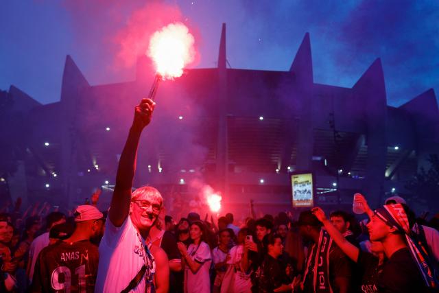 PSG supporters celebrate their team's win in the UEFA Champions League final BETWEEN Paris Saint-Germain (PSG) AND Arsenal FC played in Budapest, outside the Parc des Princes stadium in Paris on May 30, 2026. (Photo by Kenzo TRIBOUILLARD / AFP)