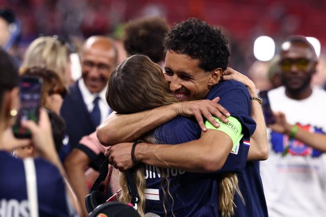 Paris Saint-Germain's Brazilian defender #05 Marquinhos hugs his wife Carol Cabrino after winning the UEFA Champions League final football match between Paris Saint-Germain (PSG) and Arsenal FC at the Puskas Arena in Budapest on May 30, 2026. (Photo by FRANCK FIFE / AFP)