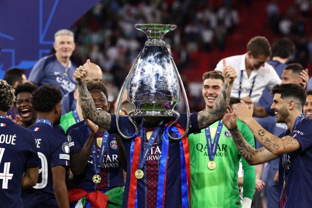 TOPSHOT - Paris Saint-Germain's French defender #21 Lucas Hernandez celebrates with the trophy after winning the UEFA Champions League final football match between Paris Saint-Germain (PSG) and Arsenal FC at the Puskas Arena in Budapest on May 30, 2026. (Photo by FRANCK FIFE / AFP)