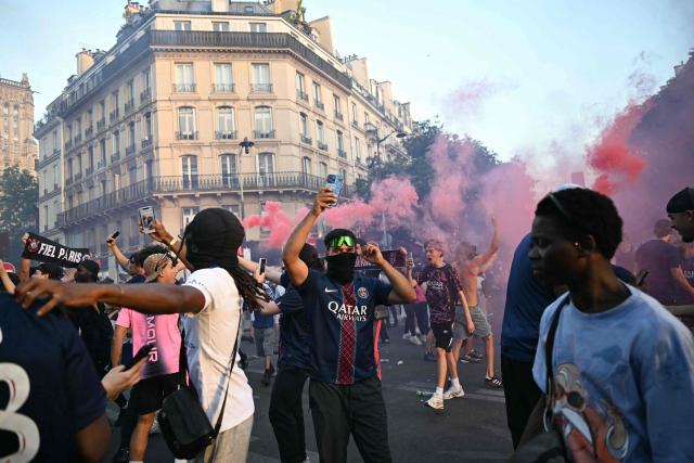 PSG supporters celebrate their team's win in the UEFA Champions League final between Paris Saint-Germain (PSG) and Arsenal FC played in Budapest, at rue de Rivoli in downtown Paris on May 30, 2026. (Photo by LOU BENOIST / AFP)