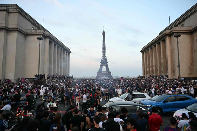 PSG supporters celebrate their team's win in the UEFA Champions League final between Paris Saint-Germain (PSG) and Arsenal FC played in Budapest, at Place du Trocadero in Paris on May 30, 2026. (Photo by LOU BENOIST / AFP)