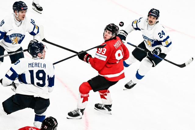 Finland's defender #10 Henri Jokiharju (L), Finland's forward #19 Waltteri Merela (2ndL), Finland's forward #24 Hannes Bjorninen (R) and Canada’s forward #93 Fraser Minten during the IIHF Ice Hockey Men's World Championship semi-final match between Canada and Finland at the Swiss Life Arena in Zurich, on May 30, 2026. (Photo by Fabrice COFFRINI / AFP)