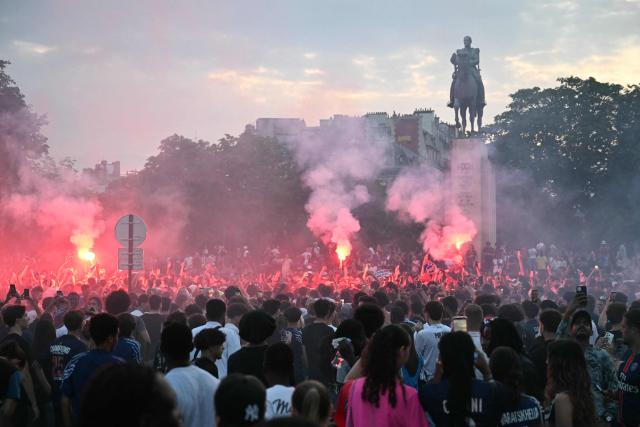PSG supporters celebrate their team's win in the UEFA Champions League final between Paris Saint-Germain (PSG) and Arsenal FC played in Budapest, at Place du Trocadero in Paris on May 30, 2026. (Photo by LOU BENOIST / AFP)