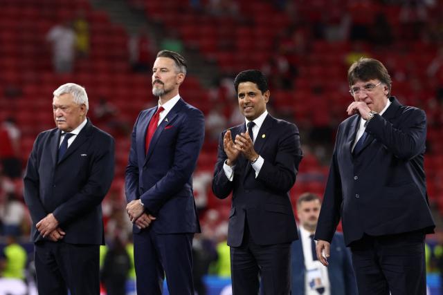 (From 2L) Co-Chair of Arsenal, Josh Kroenke, Paris Saint Germain's Qatari president Nasser al-Khelaifi and UEFA General Secretary Theodore Theodoridis look on during the trophy ceremony after aris Saint Germain won the UEFA Champions League final football match against Arsenal FC at the Puskas Arena in Budapest on May 30, 2026. (Photo by FRANCK FIFE / AFP)
