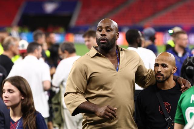 French judoka Teddy Riner (C) celebrates on the pitch after Paris Saint-Germain won the UEFA Champions League final football match against Arsenal FC at the Puskas Arena in Budapest on May 30, 2026. (Photo by FRANCK FIFE / AFP)