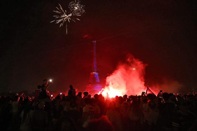 PSG supporters celebrate their team's win in the UEFA Champions League final between Paris Saint-Germain (PSG) and Arsenal FC played in Budapest, at Place du Trocadero opposite the Eiffel Tower in Paris on May 30, 2026. (Photo by LOU BENOIST / AFP)