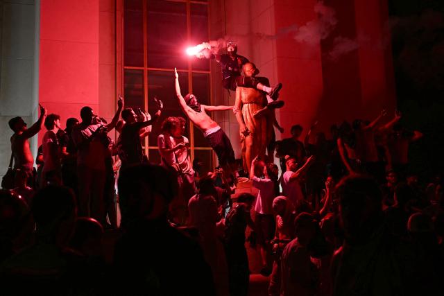 PSG supporters celebrate their team's win in the UEFA Champions League final between Paris Saint-Germain (PSG) and Arsenal FC played in Budapest, at Place du Trocadero opposite the Eiffel Tower in Paris on May 30, 2026. (Photo by LOU BENOIST / AFP)