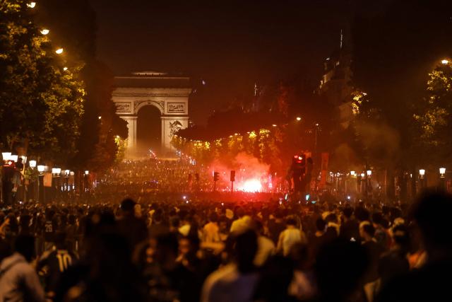 TOPSHOT - PSG supporters gather on the Champs-Elysees Avenue after the club won the UEFA Champions League final between Paris Saint-Germain (PSG) and Arsenal FC played in Budapest, in Paris on May 30, 2026. (Photo by ROMEO BOETZLE / AFP)