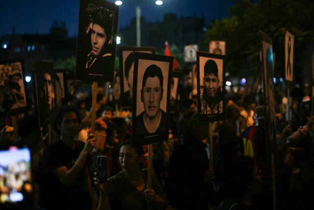 People hold photos of victims of violence from the government of Peru’s former president (1990–2000) Alberto Fujimori during a march against right-wing candidate Keiko Fujimori in Lima on May 30, 2026. Right-wing candidate Keiko Fujimori and left-wing candidate Roberto Sanchez will face off on June 7 in Peru's presidential runoff, the electoral authority confirmed on May 17 when it officially proclaimed the results. (Photo by ERNESTO BENAVIDES / AFP)