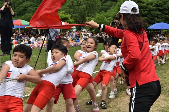 Children play tug of war at the joint friendship gathering to mark the 76th anniversary of the International Children's Day at the Taesongsan Pleasure Park in Pyongyang on June 1, 2026. (Photo by KIM Won Jin / AFP)