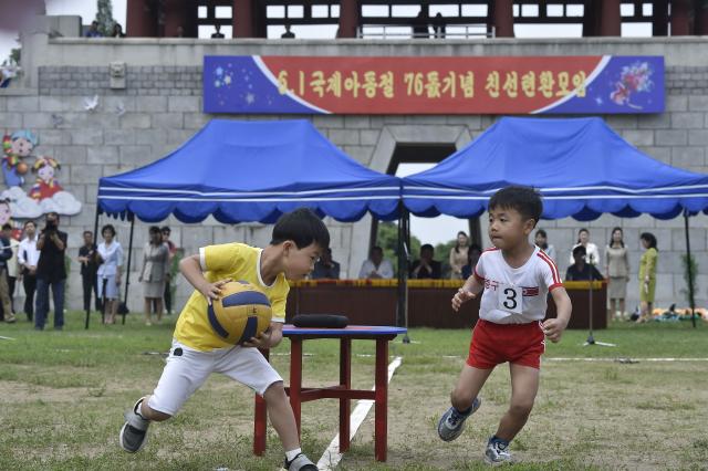 Children play ball catching at the joint friendship gathering to mark the 76th anniversary of the International Children's Day at the Taesongsan Pleasure Park in Pyongyang on June 1, 2026. (Photo by KIM Won Jin / AFP)