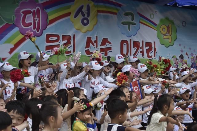 Children of the Daesong District cheer on their players at the joint friendship gathering to mark the 76th anniversary of the International Children's Day at the Taesongsan Pleasure Park in Pyongyang on June 1, 2026. (Photo by KIM Won Jin / AFP)