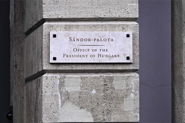 A plaque on the wall by the door reads 'Sandor-Palota (Sandor-palace) Office of the President of Hungary' in Budapest, Hungary, on June 1, 2026. The meeting takes place a day after a deadline set out by Magyar for the resignation of Sulyok has passed. The prime minister has urged top state officials, whom he called puppets of his predecessor, to step down by the end of May or face removal from office. (Photo by Attila KISBENEDEK / AFP)