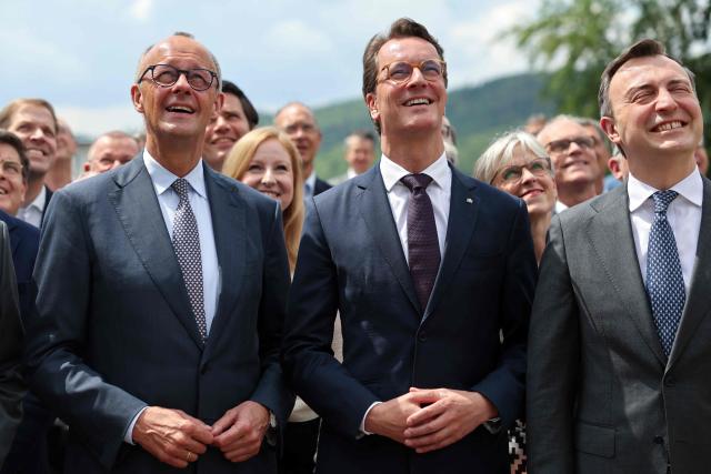 (LtoR) German Chancellor and leader of Germany's Christian Democratic Union (CDU) Friedrich Merz, North Rhine-Westphalia's State Premier and leader of the state's CDU Hendrik Wuest, and NRW's CDU Secretary General Paul Ziemiak and other participants gather for a group photo in Meschede, western Germany, on June 1, 2026, during a two-day party meeting to prepare for the 2027 North Rhine-Westphalia state elections. (Photo by Oliver Berg / POOL / AFP)