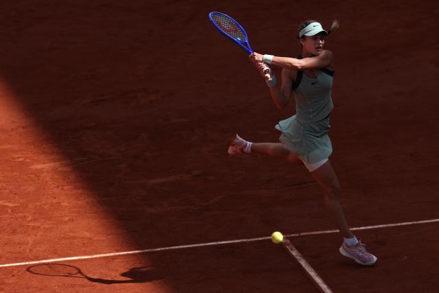 Anna Kalinskaya plays a backhand return to Austria's Anastasia Potapova during their women's singles match on day 9 of the French Open tennis tournament on Court Suzanne-Lenglen at the Roland-Garros Complex in Paris on June 1, 2026. (Photo by Anne-Christine POUJOULAT / AFP)