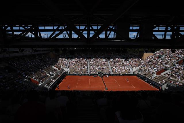 Austria's Anastasia Potapova (L) plays a forehand return to Anna Kalinskaya during their women's singles match on day 9 of the French Open tennis tournament on Court Suzanne-Lenglen at the Roland-Garros Complex in Paris on June 1, 2026. (Photo by Anne-Christine POUJOULAT / AFP)