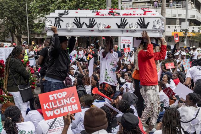 Protesters carry an empty coffin as they stage a sit in during a protest against an alarming rise in femicide cases, in Nairobi on June 1, 2026. (Photo by SIMON MAINA / AFP)