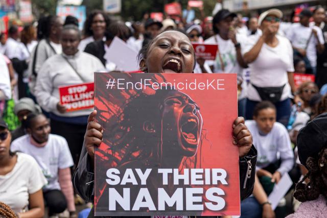 TOPSHOT - A protester holds a placard reading "Say their names" during a protest against an alarming rise in femicide cases, in Nairobi on June 1, 2026. (Photo by SIMON MAINA / AFP)